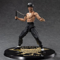 Bruce Lee: S.H.Figuarts Bruce Lee Legacy 50th Version – front view on black display base with nunchaku